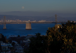 full moon rising over Bay Bridge